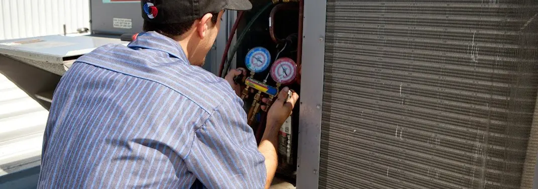 HVAC technician servicing a condenser unit in Bonita Springs